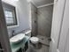 Modern bathroom featuring a sleek vanity, toilet, and tiled walk-in shower at 1816 Phillips Dr, Sanford, NC 27330