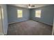 Bedroom with two windows, ceiling fan, carpet flooring, and neutral walls at 1816 Phillips Dr, Sanford, NC 27330