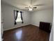 Bedroom with hardwood floors, ceiling fan, window, and dresser at 1816 Phillips Dr, Sanford, NC 27330