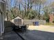 Concrete driveway, shed and wooded backyard with privacy fence are perfect for extra storage at 1816 Phillips Dr, Sanford, NC 27330