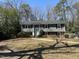 Traditional home featuring a well-maintained lawn, walkway, and a welcoming front porch with a bright blue door at 1816 Phillips Dr, Sanford, NC 27330
