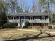 Charming two-story home with a blue door, black shutters and a well-maintained front yard at 1816 Phillips Dr, Sanford, NC 27330