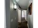 Hallway view with stone tile flooring, board and batten accent wall, and access to rooms at 1816 Phillips Dr, Sanford, NC 27330