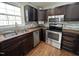 Well-equipped kitchen with stainless steel appliances and dark wood cabinets at 1816 Phillips Dr, Sanford, NC 27330