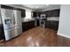 Modern kitchen with stainless steel appliances, dark wood cabinets, and a stylish backsplash at 1816 Phillips Dr, Sanford, NC 27330