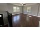 Sunlit living room featuring hardwood floors, neutral walls, and a modern ceiling fan at 1816 Phillips Dr, Sanford, NC 27330