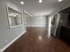 Open-concept living area connecting the kitchen and dining space with hardwood floors at 1816 Phillips Dr, Sanford, NC 27330