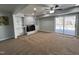 Open-plan living room with brick fireplace and sliding glass doors to backyard at 1816 Phillips Dr, Sanford, NC 27330