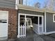 This covered patio features a picket fence, providing a charming transition to the outdoor space and additional storage at 1816 Phillips Dr, Sanford, NC 27330