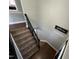 A view looking down the staircase with dark wood handrail at 1816 Phillips Dr, Sanford, NC 27330