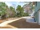 Expansive backyard featuring a large driveway, lush greenery, and potential for outdoor activities at 1900 Sunset Ave, Durham, NC 27705