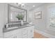Bright bathroom featuring double vanity, gray countertops, modern fixtures, and a large framed mirror at 1900 Sunset Ave, Durham, NC 27705