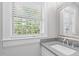 Bright bathroom featuring a large window and a neutral color palette at 1900 Sunset Ave, Durham, NC 27705