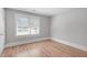 Bright bedroom with hardwood floors, white trim, and a large window providing natural light and street views at 1900 Sunset Ave, Durham, NC 27705