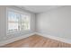 Neutral bedroom with hardwood floors, window with blinds, and minimalist design, offering a calming atmosphere at 1900 Sunset Ave, Durham, NC 27705