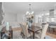 Dining area with dark wooden table, soft seating, and chandelier at 1900 Sunset Ave, Durham, NC 27705