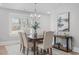 Dining room with elegant table setting, hardwood flooring, and large window at 1900 Sunset Ave, Durham, NC 27705