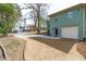 Long driveway leading to an attached garage, with a well-maintained lawn and landscaped yard at 1900 Sunset Ave, Durham, NC 27705