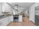 Modern kitchen with stainless steel range, stone countertops, and open view into the dining area at 1900 Sunset Ave, Durham, NC 27705