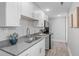 Modern kitchen boasts stainless steel appliances, white cabinetry, and gray countertops at 1900 Sunset Ave, Durham, NC 27705