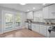 Bright kitchen with stainless steel appliances, stone countertops, and doors to a deck at 1900 Sunset Ave, Durham, NC 27705