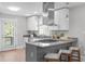Well lit kitchen featuring a large island with seating and modern stainless appliances at 1900 Sunset Ave, Durham, NC 27705