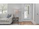Cozy living room area with comfortable couch and view to the outside through glass paned door at 1900 Sunset Ave, Durham, NC 27705