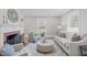 Inviting living room featuring a fireplace, plush seating, ottoman, and large window at 1900 Sunset Ave, Durham, NC 27705