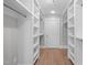Spacious walk-in closet with built-in shelving and hardwood floors, offering ample storage space at 1900 Sunset Ave, Durham, NC 27705