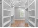 Well-organized walk-in closet featuring custom shelving and hardwood floors, providing plenty of storage at 1900 Sunset Ave, Durham, NC 27705