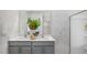 Bright bathroom with double sinks, gray cabinets and wallpaper, offering a clean and stylish aesthetic at 20 Granite Falls Way, Youngsville, NC 27596