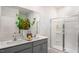 Modern bathroom featuring double sink vanity, granite countertops, and a walk-in shower with glass door at 20 Granite Falls Way, Youngsville, NC 27596