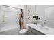 Well-lit bathroom with a shower-tub combo, neutral finishes, and a modern vanity at 20 Granite Falls Way, Youngsville, NC 27596
