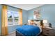 Inviting bedroom featuring a blue duvet, yellow curtains, and playful artwork at 20 Granite Falls Way, Youngsville, NC 27596