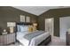 Cozy bedroom with a comfortable bed, neutral color scheme, and ensuite bathroom at 20 Granite Falls Way, Youngsville, NC 27596
