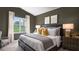 Tranquil bedroom featuring neutral decor, a comfortable bed, and a view of the backyard at 20 Granite Falls Way, Youngsville, NC 27596