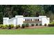 Community entrance with the Baker Farm sign, lush landscaping and green grass at 20 Granite Falls Way, Youngsville, NC 27596