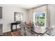 Bright dining room with large window, stylish chairs, and hardwood floors at 20 Granite Falls Way, Youngsville, NC 27596