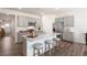 Modern kitchen features gray cabinets, stainless steel appliances, and granite countertops with seating at 20 Granite Falls Way, Youngsville, NC 27596