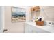 Well-equipped laundry room with white washer and dryer, wire shelving, and decorative accents at 20 Granite Falls Way, Youngsville, NC 27596