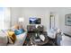 Comfortable living room with stylish decor, sofa, accent chair, and modern entertainment center at 20 Granite Falls Way, Youngsville, NC 27596