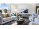 Cozy living room features a comfortable sofa, modern decor, and plenty of natural light at 20 Granite Falls Way, Youngsville, NC 27596