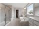Bathroom featuring a soaking tub, walk-in shower, and double vanity at 2005 Ernesto Ln, Raleigh, NC 27603