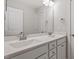 Bright bathroom featuring double sinks, white cabinetry, and a large mirror, creating a clean and modern aesthetic at 2005 Ernesto Ln, Raleigh, NC 27603