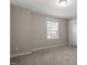 Neutral bedroom with large window, carpeted floor, and base trim at 2005 Ernesto Ln, Raleigh, NC 27603