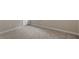 Empty bedroom with carpeted floor, white base trim, and neutral colored walls at 2005 Ernesto Ln, Raleigh, NC 27603