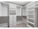 Large walk-in closet with custom shelving and storage drawers at 2005 Ernesto Ln, Raleigh, NC 27603