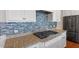 Kitchen featuring stainless steel appliances, granite countertops and stylish blue backsplash at 2005 Ernesto Ln, Raleigh, NC 27603