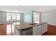 Kitchen island with granite countertop, white cabinets, stainless steel dishwasher and double sink at 2005 Ernesto Ln, Raleigh, NC 27603