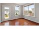 Empty room with hardwood floors, a glass door, and bright windows offering natural light at 2005 Ernesto Ln, Raleigh, NC 27603
